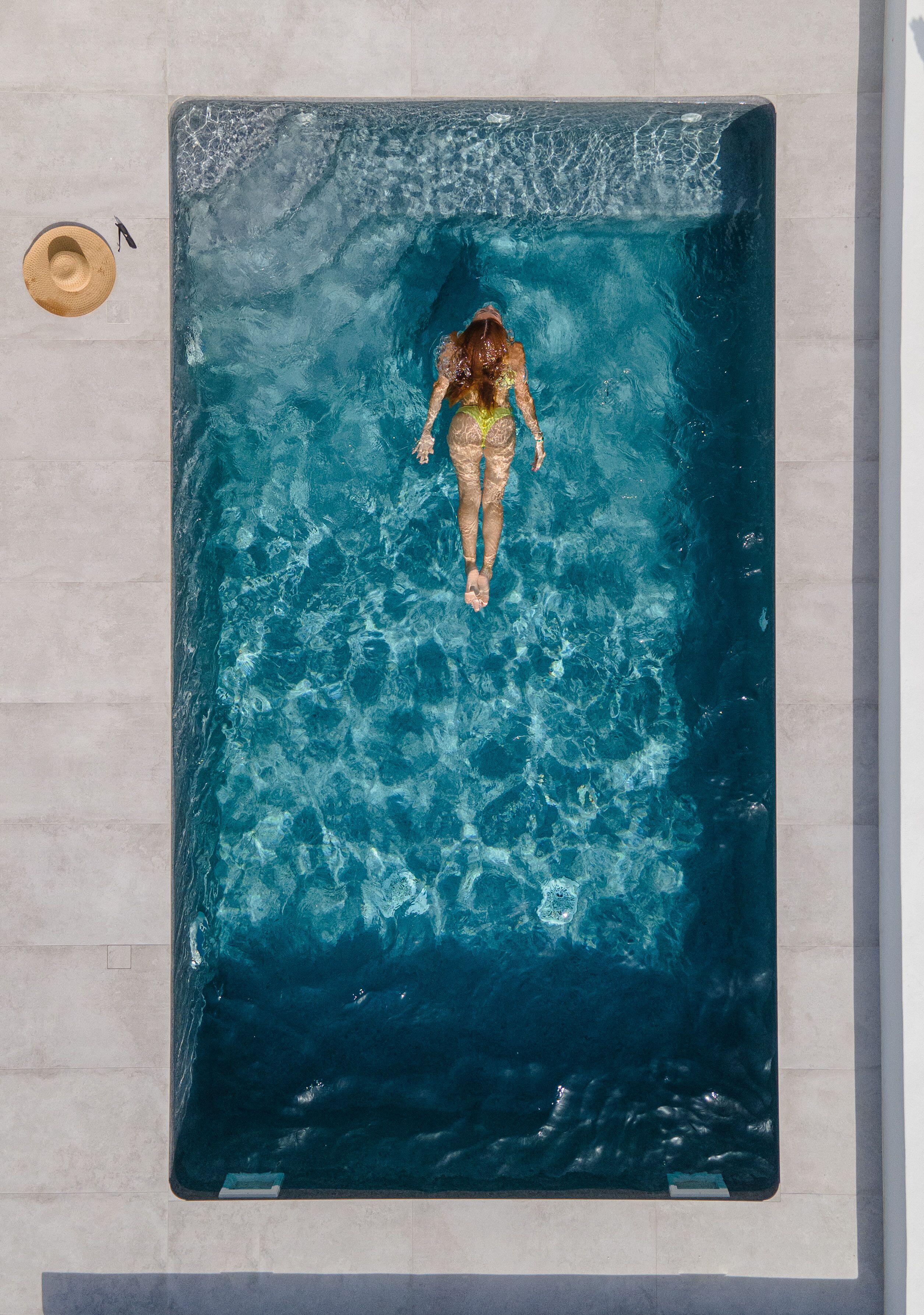 A rectangular swimming pool with clear blue water.