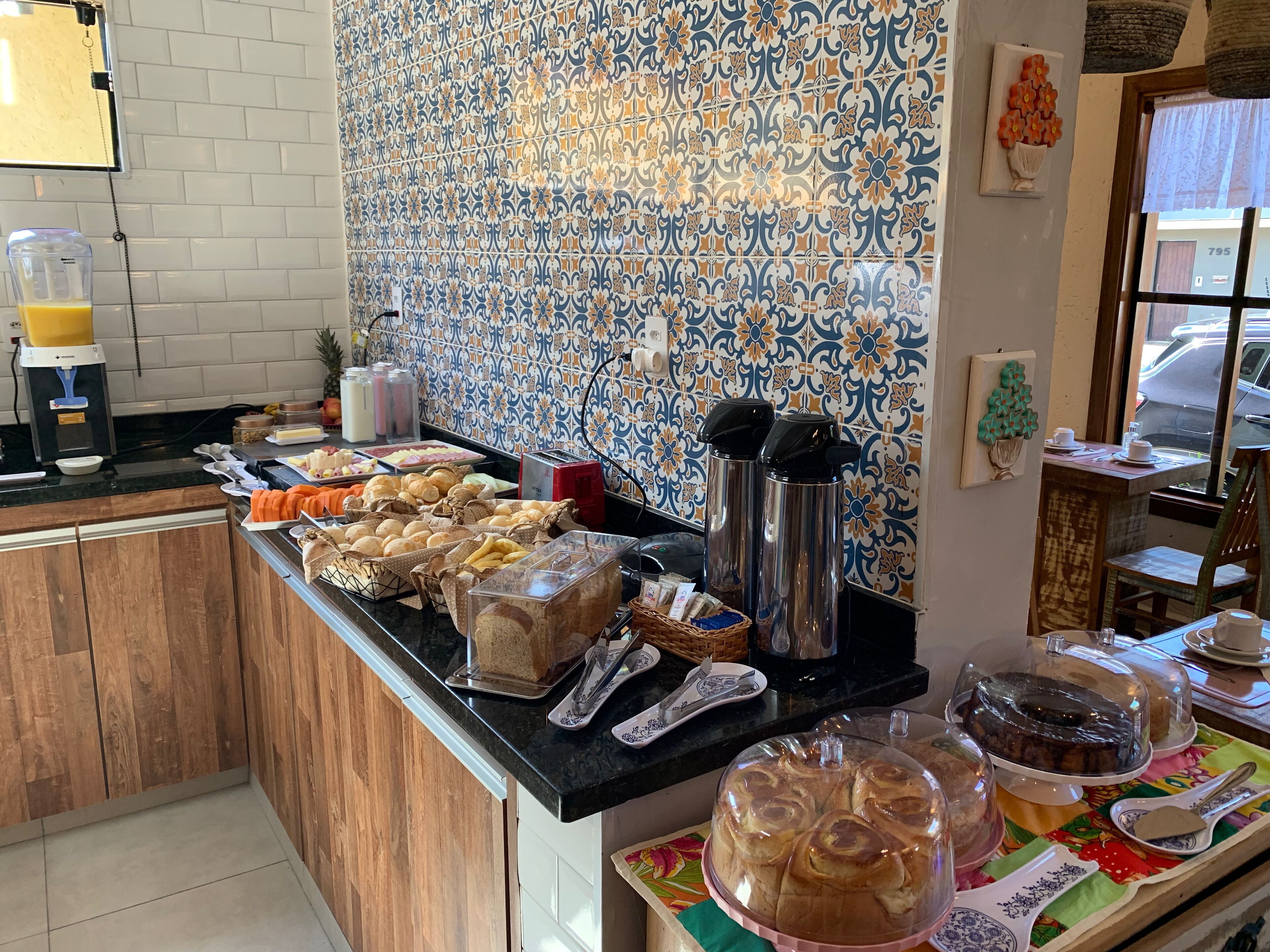 A breakfast buffet with various food items and a coffee machine.