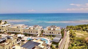 A coastal resort with multiple buildings, a swimming pool, and a view of the ocean. - Turtle Villa 0120 @ Las Palmas Beach, Dixon Cove (Dixon Cove)