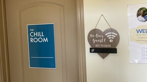 A door with a sign reading "The Chill Room" and a heart-shaped sign with "Be Our Guest!" and a WiFi password. - WHOLE Family - Barrette - Hostel (Sacramento)