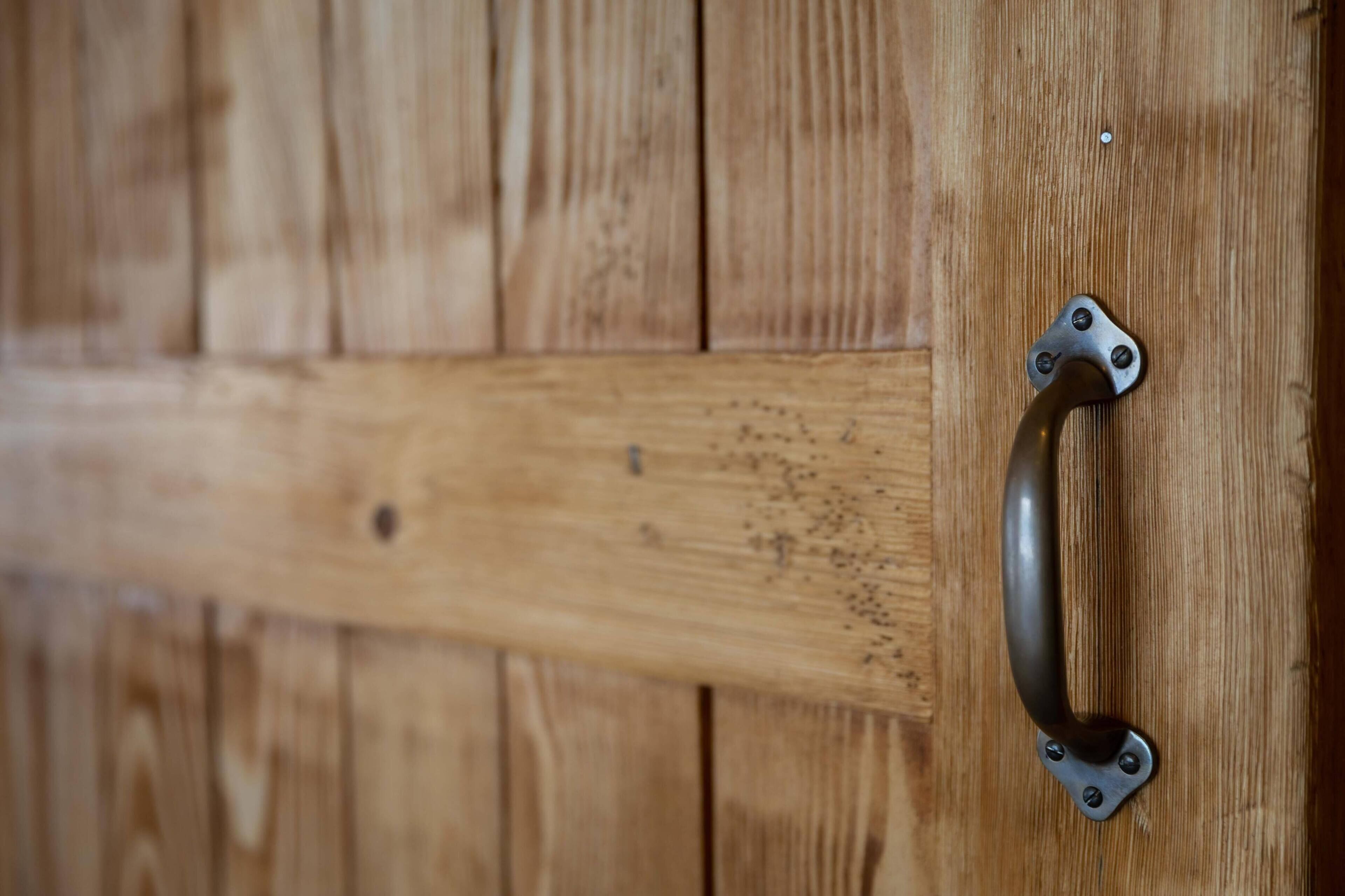 A wooden door with a metal handle.