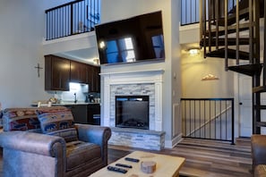 Cozy living area with a fireplace, comfortable seating, and a TV.