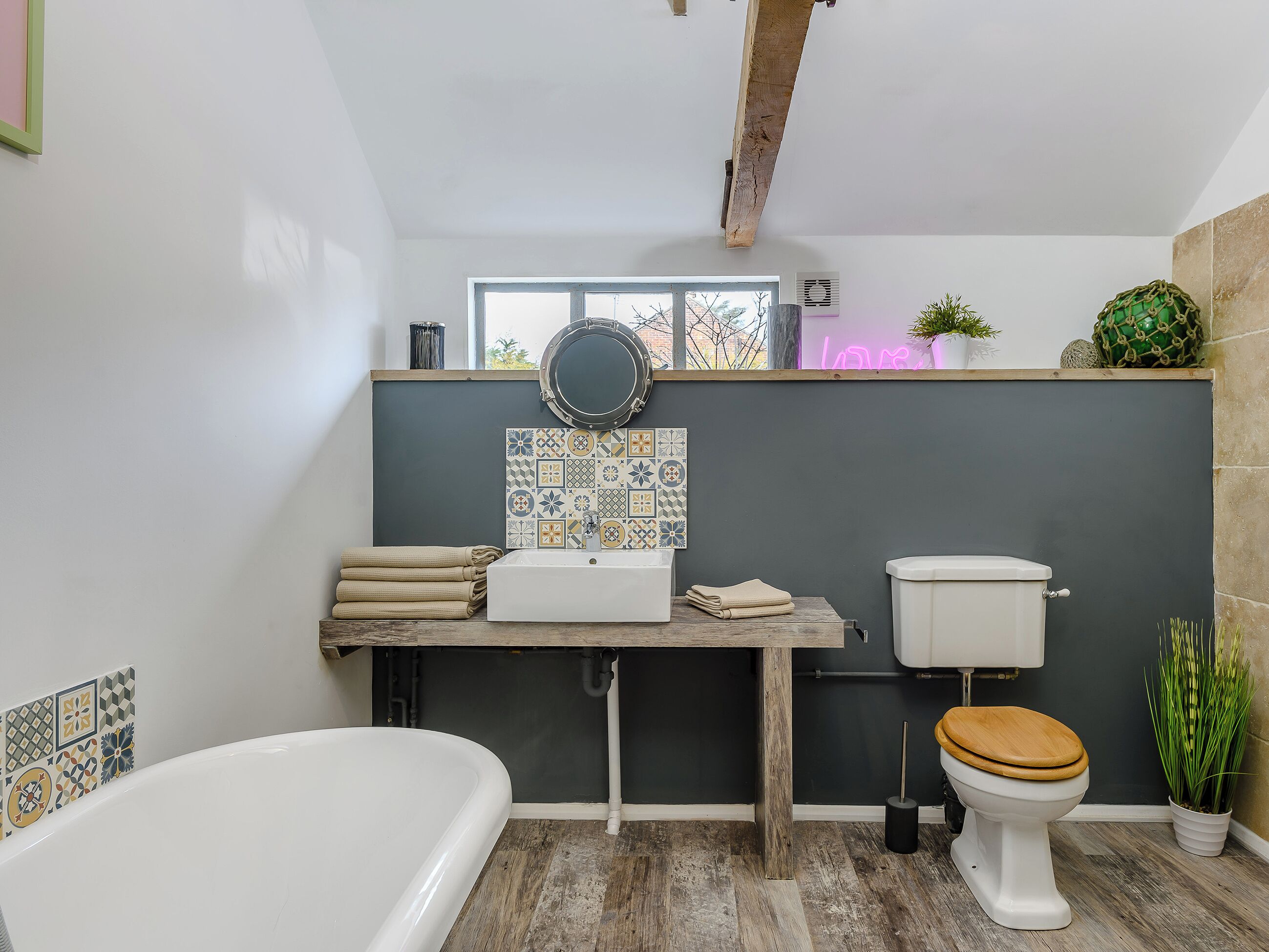 A bathroom with a bathtub, toilet, and sink.
