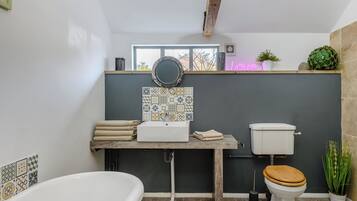 A bathroom with a bathtub, toilet, and sink.