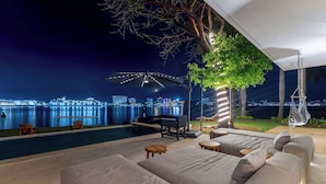A poolside area with a sofa, chairs, and a grill. - Casa Luna del Mar - Private Pool & Beach, FastWifi (Puerto Vallarta)