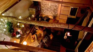 Una cocina rústica y estrecha, con vigas de madera, un lavabo y diversos utensilios de cocina.