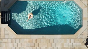 An aerial view of a rectangular swimming pool with clear water, surrounded by a tiled deck. - Private Estate w/ Heated Pool, Pond & 10 Acres (Accord)