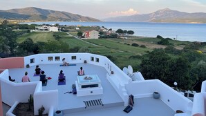 A rooftop yoga area with a scenic view of the sea and mountains. - Nisea Hotel Samos (Samos)