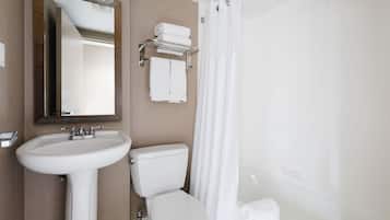 A bathroom with a white sink, toilet, and bathtub.