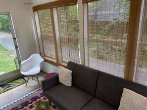 Relax in this stylish living room with a sofa, chair, and colorful rug.