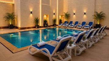 A poolside area with lounge chairs and potted plants.