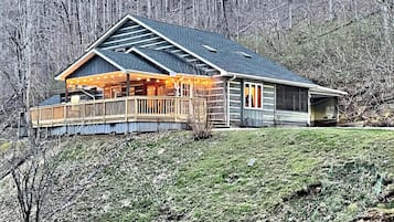 Escape to a secluded cabin-style retreat surrounded by lush woods and a serene landscape.