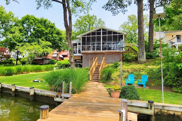 Enjoy screened in porch with dining table and sitting area