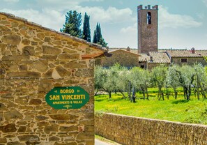 A stone building with a sign reading "Borgo San Vincenti Apartments & Villas."