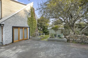 Experience a serene retreat surrounded by a well-maintained garden and an entrance.