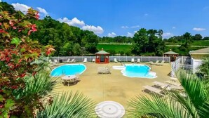 A backyard with a swimming pool, lounge chairs, and a gazebo. - Lovely Lake Condo with BOAT SLIP and Pool (Alexander City)
