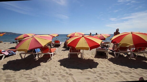 A beach with rows of sun umbrellas and beach chairs. - 2190 LAS MURALLAS 1-1, VERY WELL LOCATED, CLOSE TO SHOPS AND THE BEACH, CIUDADELA DE ROSES AREA. (Roses)
