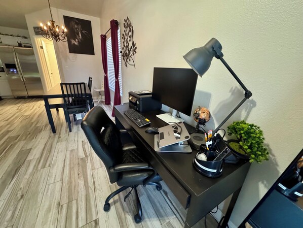 A home office with a desk, computer, and chair. - Lovely, Peaceful, and Modern Las Vegas Home! Close to Strip! (North Las Vegas)