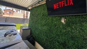 A hot tub area with a wall-mounted sign that reads 'NETFLIX'.