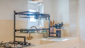 A kitchen with a gas stove, a sink, and a countertop with a utensil holder. - Villa in Ostuni with 1 bedrooms sleeps 2 (Ostuni)