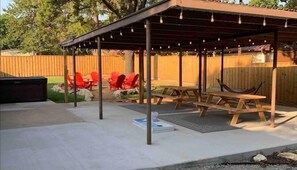 Relax in a serene outdoor space with a hammock, tables, and chairs.
