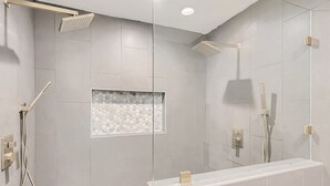 A modern bathroom with a shower, a glass-enclosed vanity, and a hexagonal tile backsplash. - Beautiful Fully Remodeled Home (Austin)