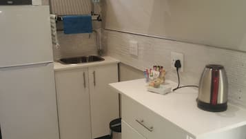 Fridge, microwave, electric kettle, cookware/dishes/utensils