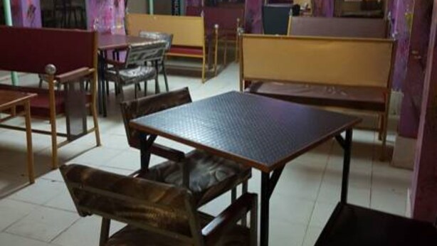 A restaurant with booths, tables, and chairs. - Jaybee's Resort (Eldoret)
