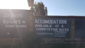 A sign for Jaybees Resort advertising accommodation with competitive rates and providing reservation contact numbers. - Jaybee's Resort (Eldoret)