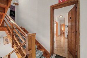 A wooden staircase with patterned carpet leading to a room. - Pet-Friendly Apartment B Armonia Rural with Sea View, Terrace, Shared Pool & Wi-Fi (Granadilla de Abona)