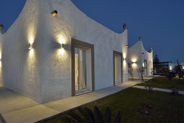 A modern building with a unique architectural design, featuring a series of connected rooms with exterior lighting. - Dune di Marispica (Ispica)