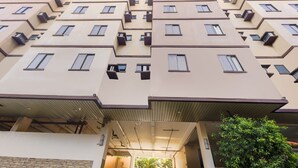 Edifício residencial de vários andares com design arquitetônico moderno, apresentando uma série de varandas e janelas.