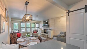 A spacious kitchen with a dining area, large windows, and a fireplace. - 'Nature Retreat' at Seventh Mountain Resort! (Bend)
