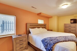 A bedroom with a wooden bed, a nightstand, a dresser, and a window with blinds. - Sturgis Rally Home Base for Riders & Couples! (Lead)