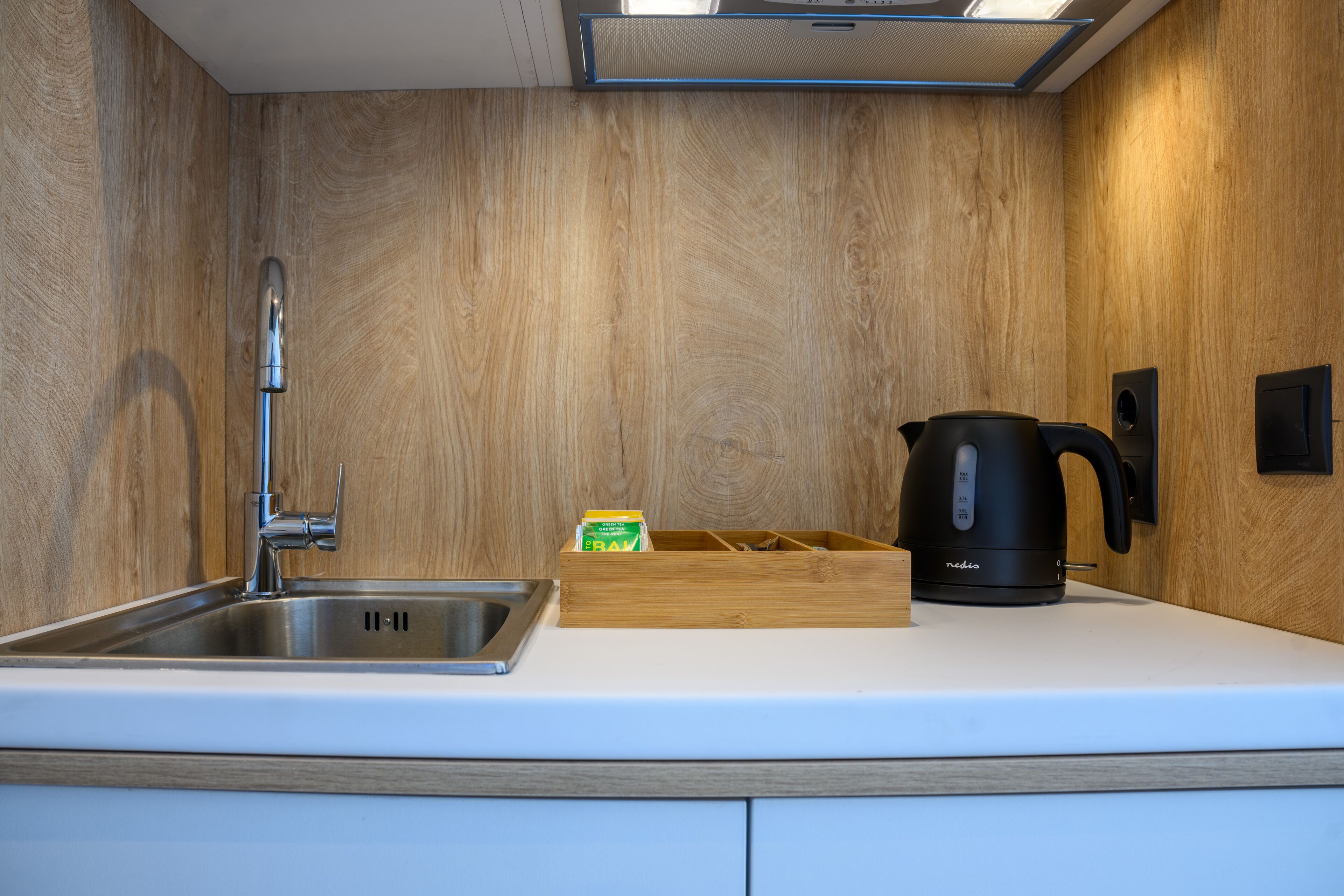 mini-fridge, stovetop, electric kettle, cookware/dishes/utensils