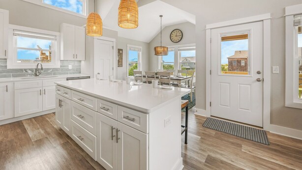 A spacious kitchen with white cabinetry, a large island, and pendant lighting. - Semi-Oceanfront Home w/ Private Pool, Tiki Bar, Hot Tub (Salvo)