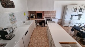 A modern kitchen with white cabinetry, a built-in oven, a microwave, and a coffee machine. - Villa close to the beach with exceptional views. (Port-la-Nouvelle)