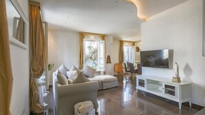 A modern living room with a sofa, TV, and a white cabinet. - Rn-c357-dpre31at - Villa Corona 8 (Cattolica)