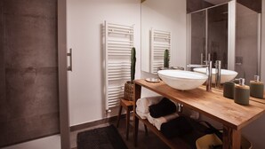 A modern bathroom with a wooden vanity, two sinks, a large mirror, and a shower area. - Apartment with sauna at the foot of the Citadel (Besançon)