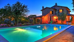 A stone house with a swimming pool, surrounded by a fence and potted plants. - Tr-a691-basc0at - Villa Poggio Verde 6 (Baschi)