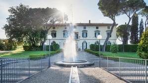 A classical building with a central fountain, surrounded by a gravel pathway and metal railings. - Gr-d948-lpog0at - Villa Croci 26 (Gavorrano)
