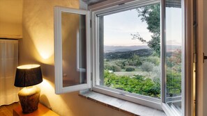 Enjoy a serene view of the surrounding landscape from the large window in this peaceful room.