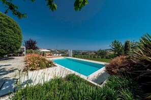 A swimming pool with a view of the countryside.