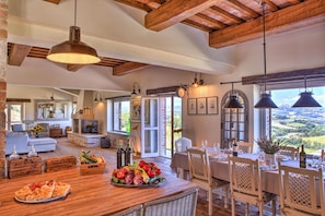 Enjoy meals in a warm and inviting dining area with a large table and comfortable seating.