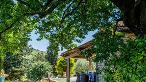 A covered outdoor seating area with stone walls and lush greenery. - Il Castellaccio 8 in Brisighella (Brisighella)