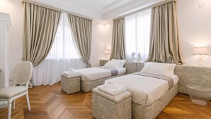 A hotel room with two beds, a chair, a small table, and a lamp. - Villa La Perla Bianca 10 (Empoli)