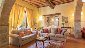 A cozy living room with two sofas, a coffee table, and a patterned rug. - Villa Santa Maria 14 (Castelnuovo Berardenga)