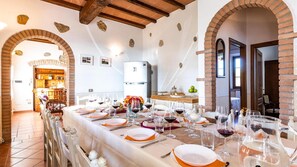 Enjoy a formal dining experience in this beautifully appointed room with a long table set for a meal.