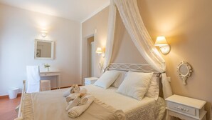 A neatly arranged bedroom with a bed, bedside tables, a vanity, and a mirror. - Villa D Aquino 8 2 in Casarano (Casarano)