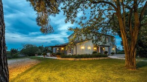 A two-story house with a well-maintained lawn, a wooden deck, and a fence. - Quercia Felice 17 in Manciano (Manciano)